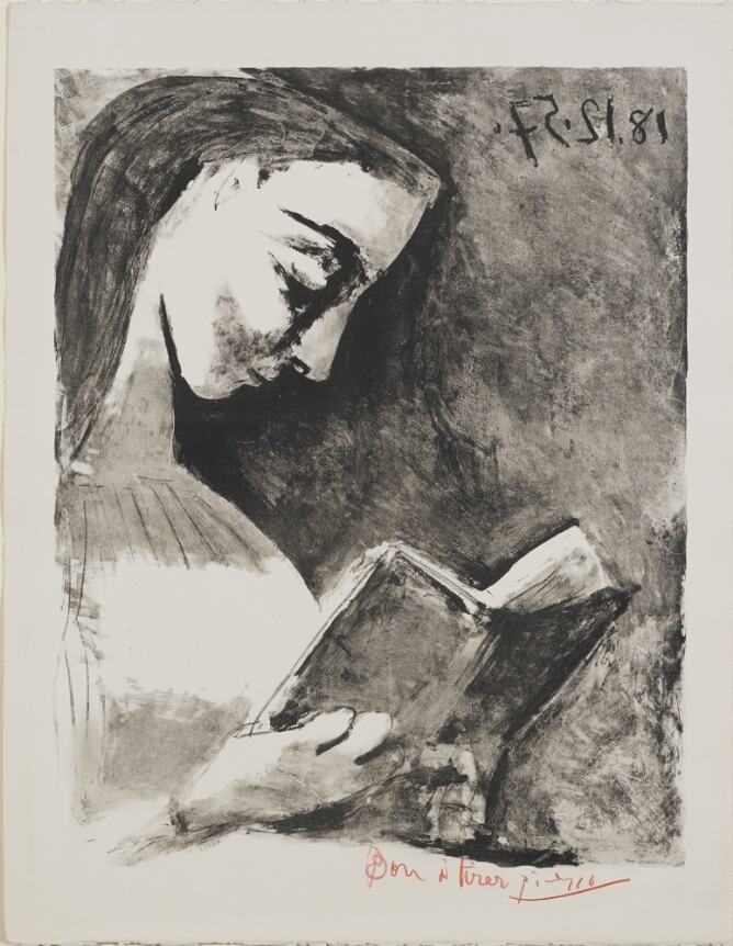 A black and white portrait of a young woman reading
