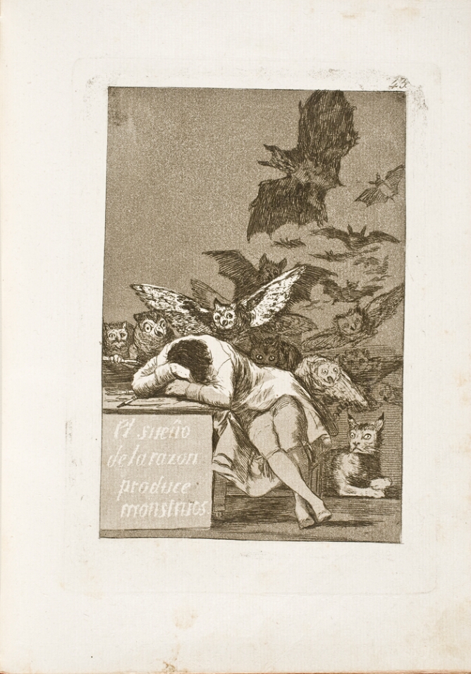 A black and white print of a man sleeping, resting his head in his arms on a desk beside him. A lynx crouches on his back, and another lynx lies on the ground, while owls and bats fly behind him. On the front of the desk, an inscription of the title