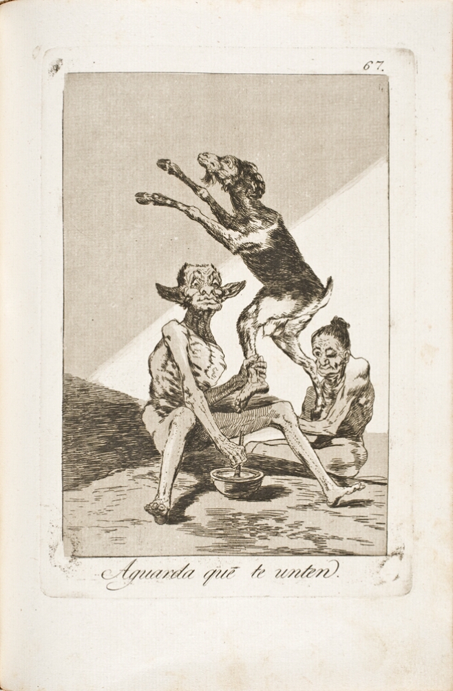 A black and white print of a seated grotesque figure holding a standing goat creature by its human ankle with one hand, while holding a brush-like instrument dipped in a bowl with the other. Another grotesque figures sits beside them