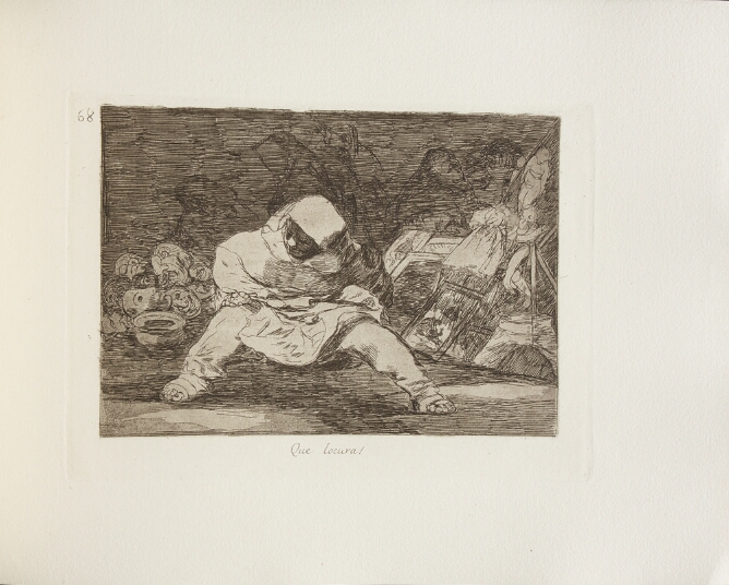 A black and white print of a hooded figure sitting with legs apart and holding a spoon. Behind, a pile of masks, other miscellaneous objects and faintly visible figures