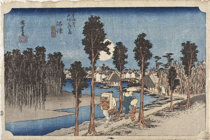 A color print of three figures walking on a tree-lined path alongside a river, approaching a town at twilight. One figure carries a box with a mask on their back