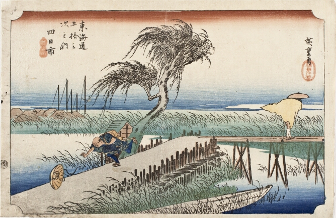 A color print of a man running along a path between a river, chasing his hat that has flown off, while another figure crosses a bridge behind, their cloak blowing in the wind