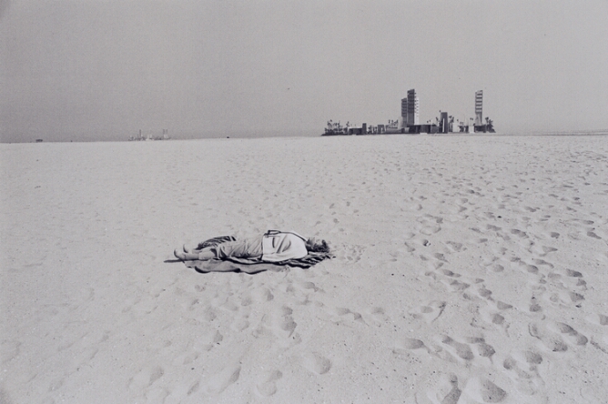 Untitled (Long Beach, Woman on Beach with Buildings in Background)