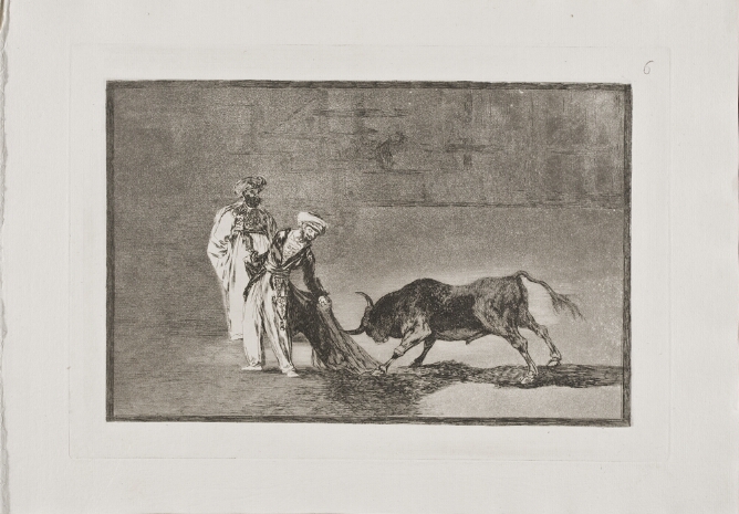 A black and white print of two standing men in an arena, with one holding a cape behind him as a bull charges towards it