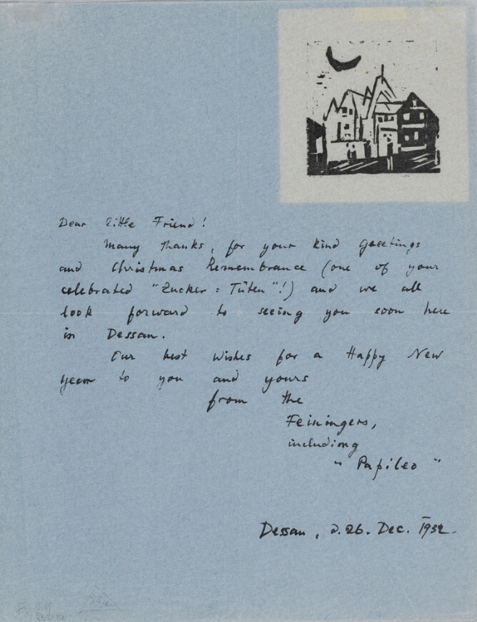 A handwritten letter with a black and white abstract print in the top right corner of a cluster of buildings and a crescent moon