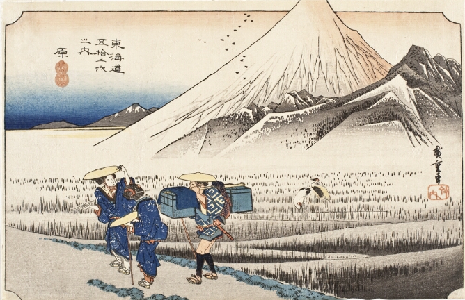 A color print of a white mountain, with its peak extending beyond the frame and a field at its base. In the foreground, figures walk along a path. A man carries luggage, while two women look back at the view
