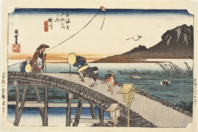 A color print of figures walking across a bridge with a field and mountain in the background. A kite is being flown to the viewer's left, while another is flying away