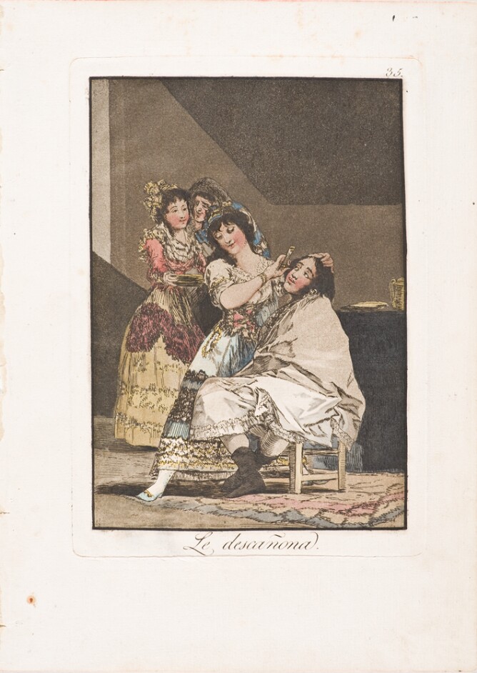 A color print of a seated man looking up at a woman shaving him, with two other women standing behind her