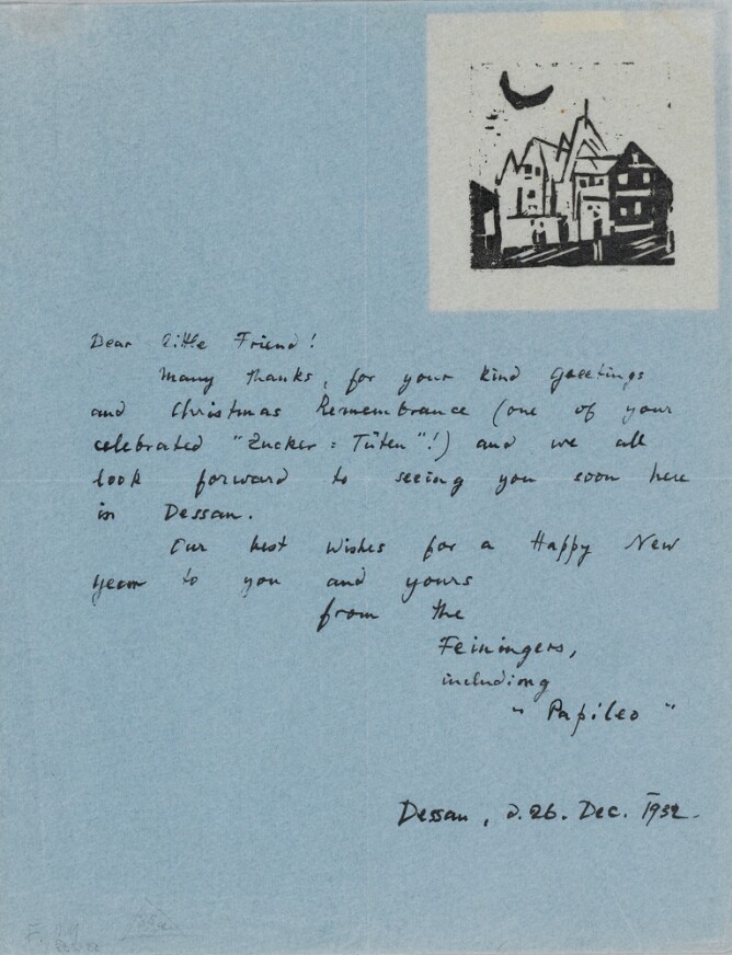 A handwritten letter with a black and white abstract print in the top right corner of a cluster of buildings and a crescent moon