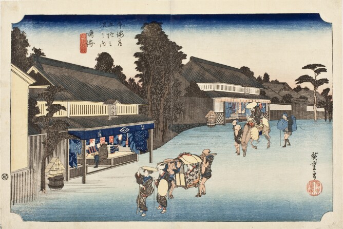 A color print of a street with blue tie-dye cloths hanging in storefronts, with a woman being transported in a covered seat, while another figure on horseback rides behind