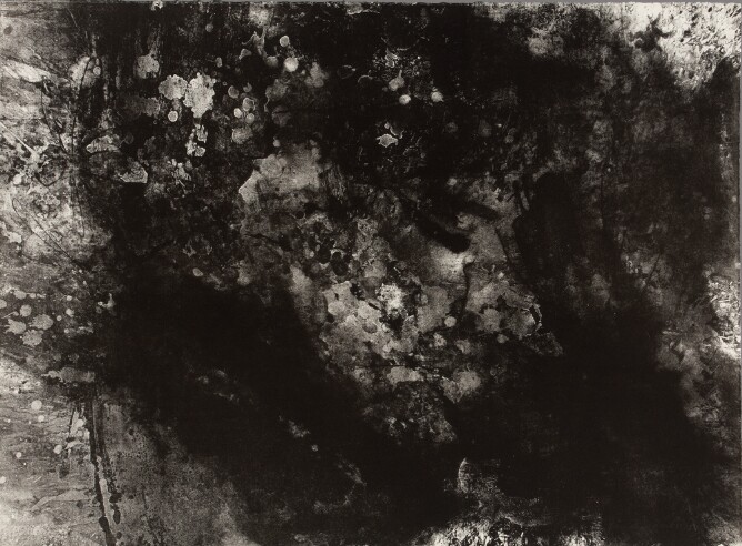 An abstract print featuring an all-over composition of textured black and gray smudges and drips