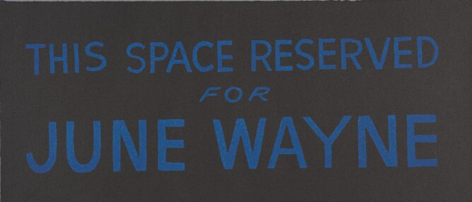 A print of large blue text against a black background that reads This Space Reserved for June Wayne